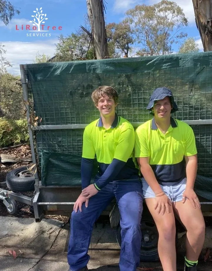 Two LiRo crew members in hi-vis sitting on the tailgate of the truck