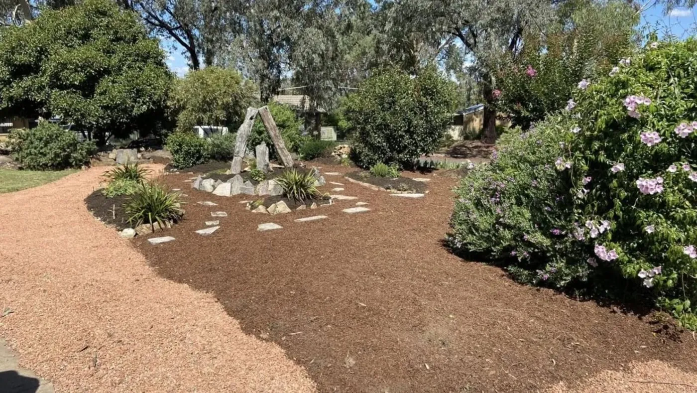 A cleared and mulched garden bed after the work, ready to plant