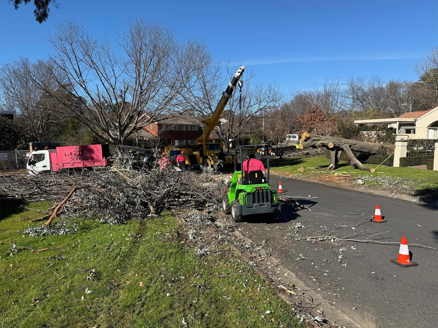 Crew and chipper truck on a Canberra street after a storm